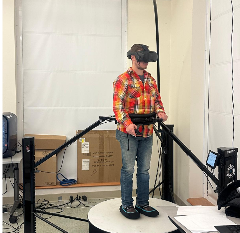 Participant using an omnidirectional treadmill in a virtual reality experiment.